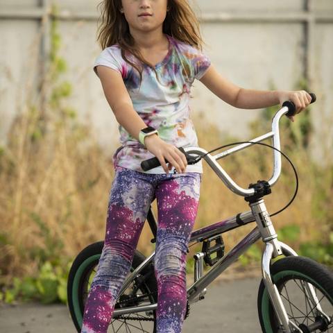 Emi standing with her BMX bike