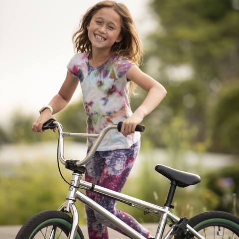 Emi smiling on her BMX bike
