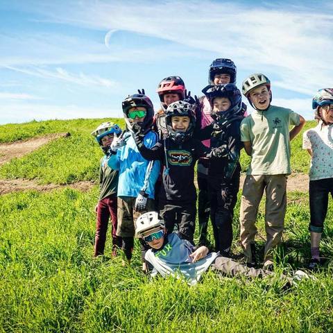 Emi with a group of young riders on a hilltop