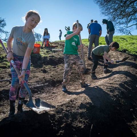 Emi digging and building a dirt track