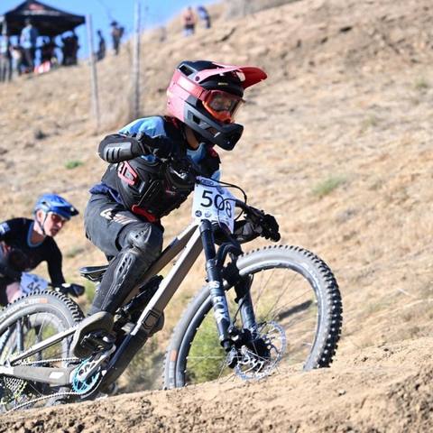 Emi leading another rider through a dual slalom turn